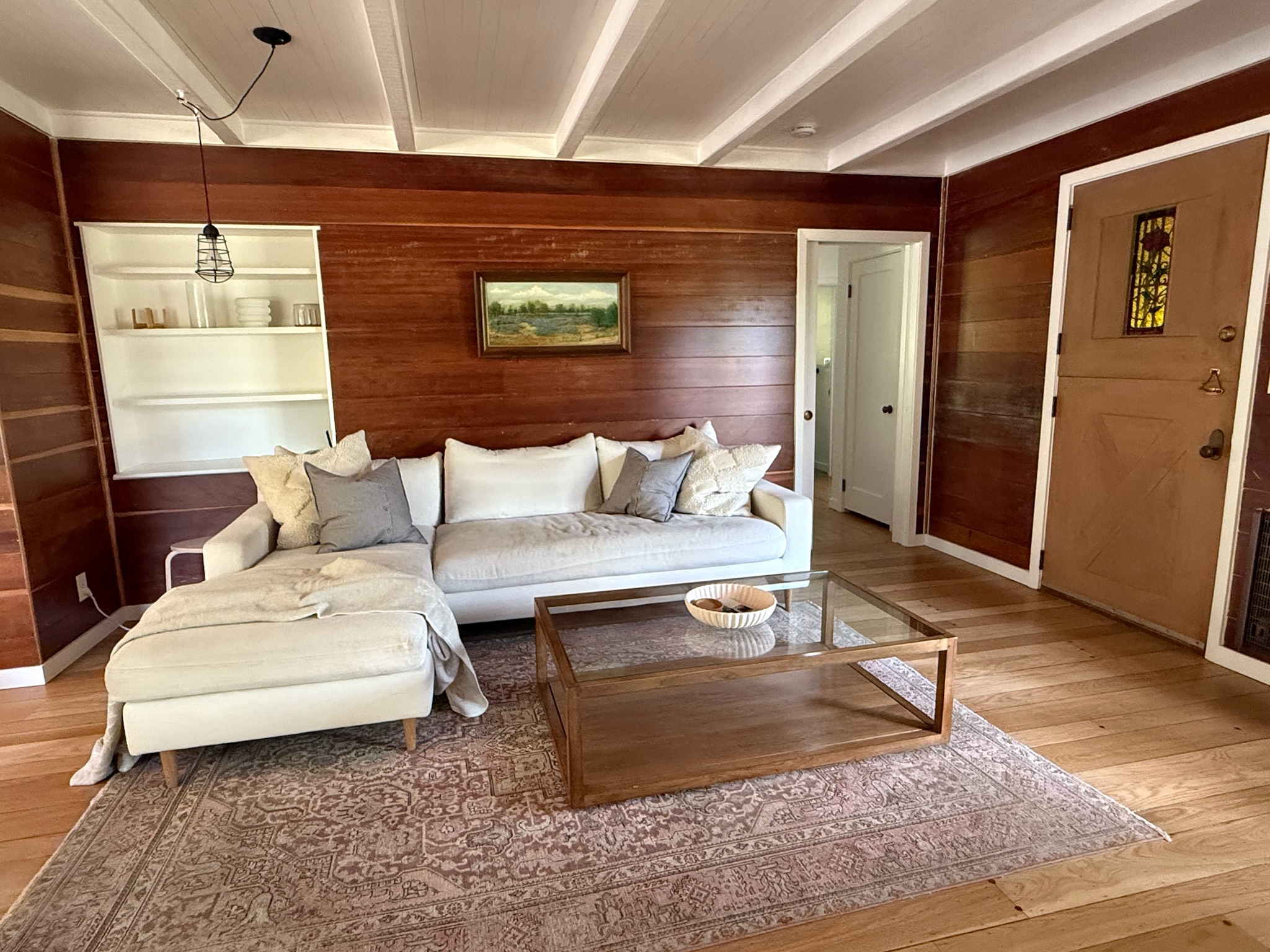 Sink into comfort in the living room, where thoughtful design details — from layered textiles to vintage touches — create a space that feels both elevated and inviting.