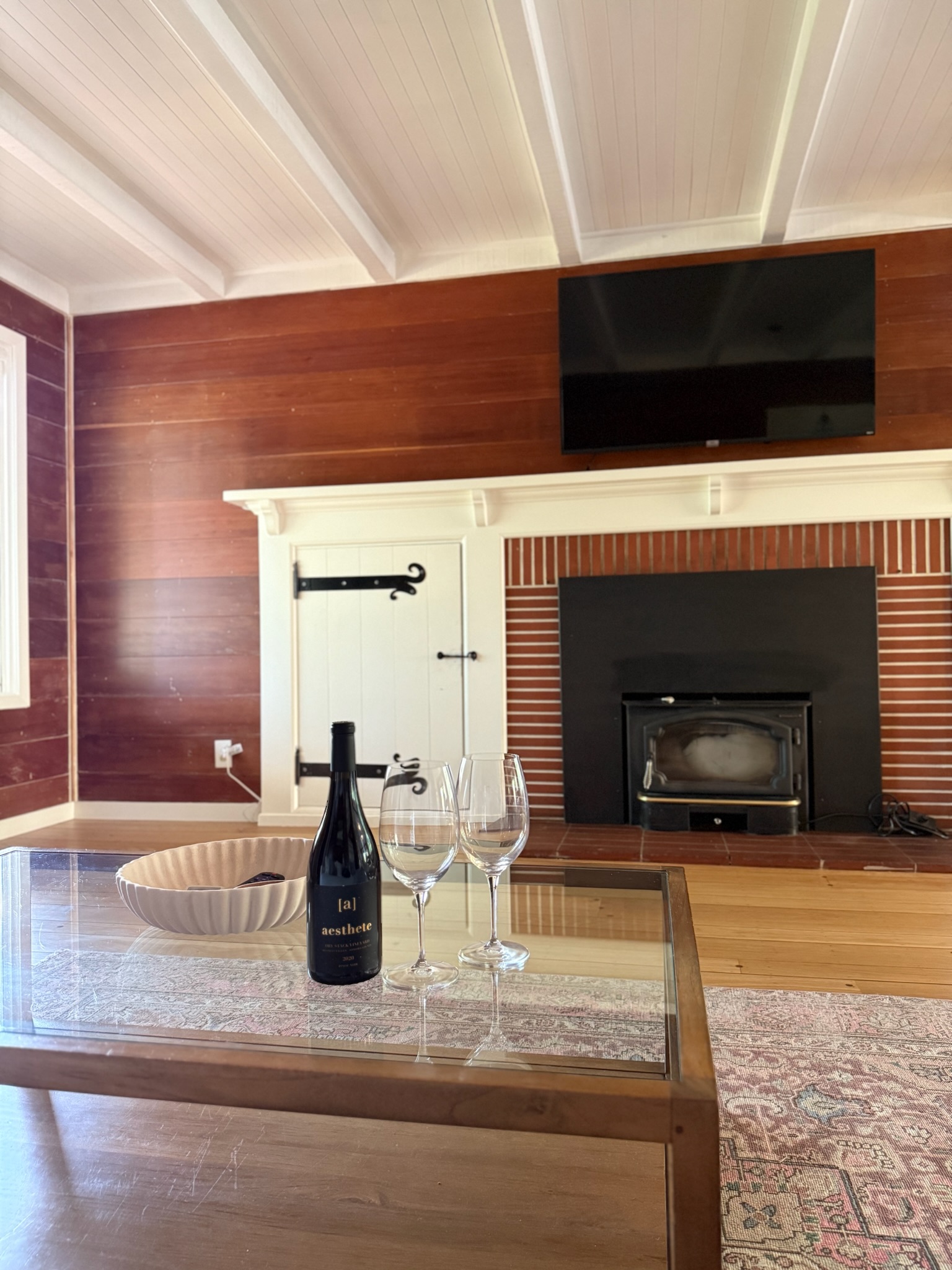 A welcoming vignette with a bottle of local wine and glasses set on the coffee table — a perfect invitation to savor the slower pace of Sonoma living.